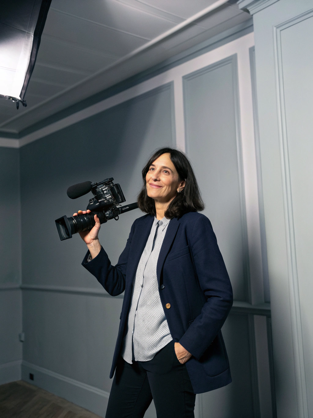 Portrait of Maya Jenson, AI Video Producer at Spotlight Digital, gold accent lighting
